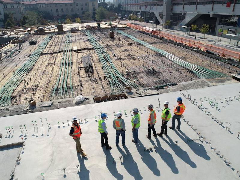 Construction crew in hard hats and safety vests on a job site