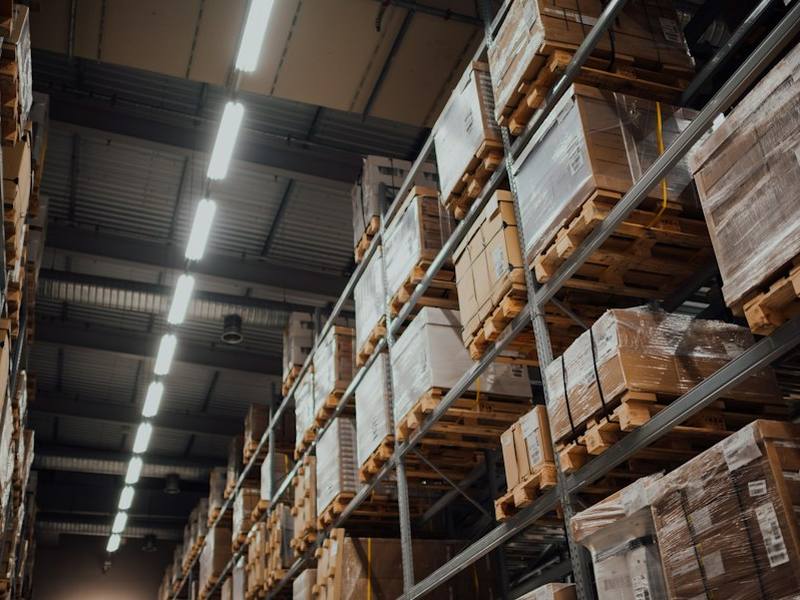 Warehouse shelves stocked with inventory boxes for order fulfillment